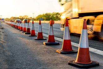 Photograph of a motorway with red cones highlighting work being undertaken