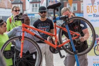 Photograph of a person checking over a bicycle