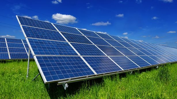 A photograph of solar panels in a field