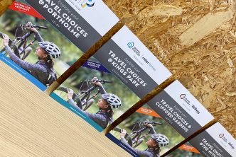 Photograph of Travel Information Guides lined up against a wall